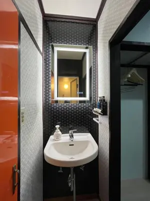 a bathroom with a sink and a mirror at Lucky Hotel in Tokyo