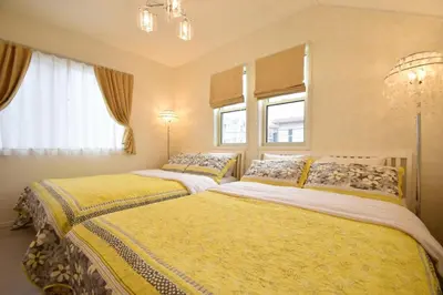 two beds in a room with two windows at Magical Dream House ★ Maihama - Vacation STAY 12402 in Tokyo