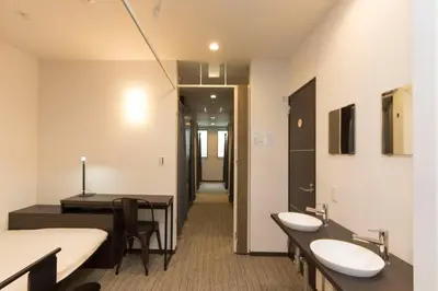 a bathroom with two sinks and a room with a table at Ryoma Ikebukuro female only -Guest House- Vacation STAY 16045v in Tokyo