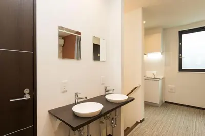 a bathroom with two sinks on a black counter at Ryoma Ikebukuro female only -Guest House- Vacation STAY 16045v in Tokyo
