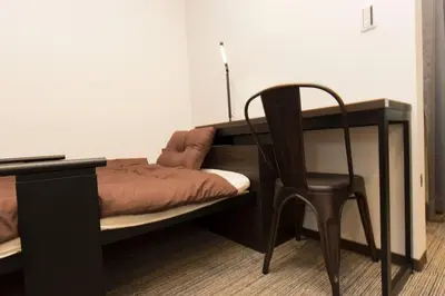 a bed with a desk and a chair next to a table at Ryoma Ikebukuro female only -Guest House- Vacation STAY 16045v in Tokyo