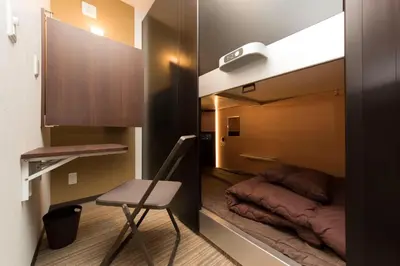 a room with a bed and a chair in a room at Ryoma Ikebukuro male only -Guest House - Vacation STAY 14547v in Tokyo