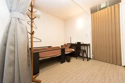 a room with a desk and a bed and a table at Ryoma Ikebukuro male only -Guest House - Vacation STAY 14547v in Tokyo