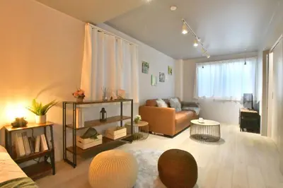 a living room with a couch and a table at FL Residence Shinjuku I in Tokyo