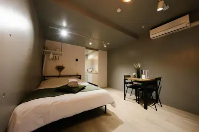 a bedroom with a bed and a desk in it at FL Residence Shinjuku I in Tokyo
