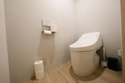 a bathroom with a toilet and two rolls of toilet paper at FL Residence Shinjuku I in Tokyo