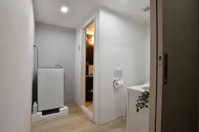 a white bathroom with a sink and a mirror at FL Residence Shinjuku I in Tokyo