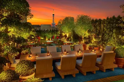 a patio with a table and chairs at sunset at The Tokyo EDITION, Ginza in Tokyo