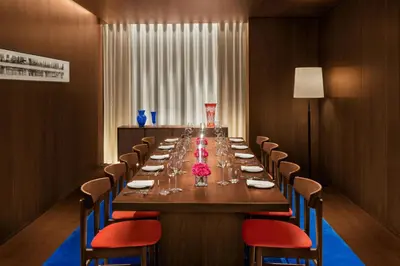 a long dining room with a long table and chairs at The Tokyo EDITION, Ginza in Tokyo