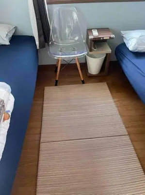 a room with a chair and a bed and a table at M&Ks house in Tokyo
