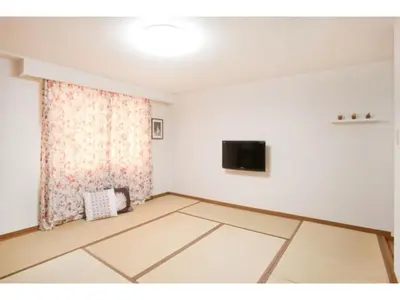 a living room with a television and a white wall at Hotel Hanabi - Vacation STAY 67145v in Tokyo