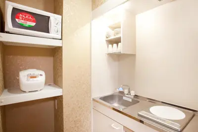 a small kitchen with a sink and a microwave at Hotel Hanabi - Vacation STAY 89136v in Tokyo