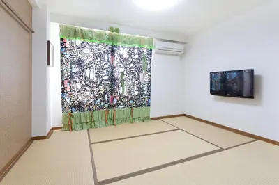 a room with a curtain and a tv on a wall at Hotel Hanabi - Vacation STAY 89124v in Tokyo
