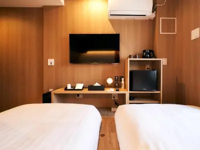 a hotel room with two beds and a television at Rakuten STAY Tokyo Asakusa in Tokyo