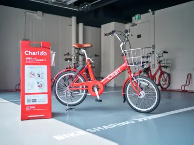 a red bike parked next to a sign in a garage at Rakuten STAY Tokyo Asakusa in Tokyo