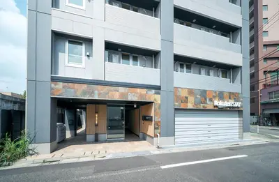 an apartment building with a garage in front of it at Rakuten STAY Tokyo Asakusa in Tokyo