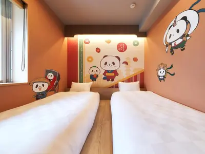 two beds in a room with cartoon characters on the wall at Rakuten STAY Tokyo Asakusa in Tokyo