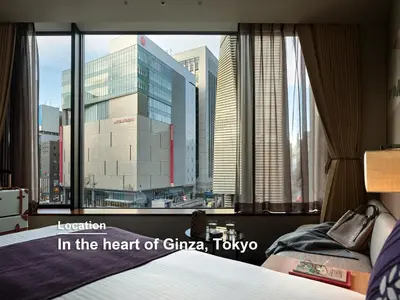 a bedroom with a large window with a view of a city at Millennium Mitsui Garden Hotel Tokyo - Ginza in Tokyo