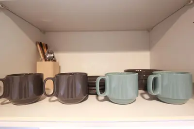 a row of coffee mugs sitting on a shelf at Shinjuku Ryokan Retreat丶Local Tokyo Experience & Short Trips Hub丶walk to Higahsi Shinjuku station YEoL in Tokyo