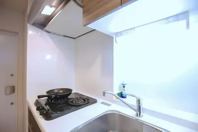a small kitchen with a stove and a sink at Shinjuku Ryokan Retreat丶Local Tokyo Experience & Short Trips Hub丶walk to Higahsi Shinjuku station YEoL in Tokyo