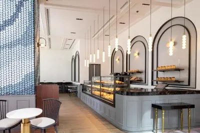 a bakery with a counter and chairs and tables at Premier hotel -CABIN PRESIDENT- Tokyo in Tokyo