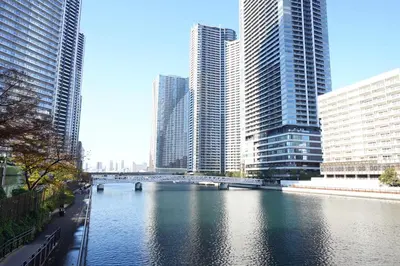 a river in a city with tall buildings and a bridge at Premier hotel -CABIN PRESIDENT- Tokyo in Tokyo