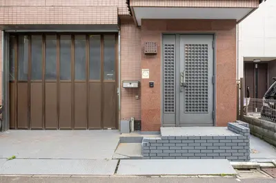 a front door of a brick building at -Hirai- 10 minutes' walk from Hirai Station Direct service to Shinjuku and Akihabara 平井戸建 in Tokyo