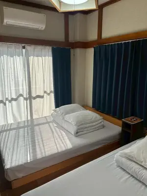 a bedroom with two beds and a window at -Hirai- 10 minutes' walk from Hirai Station Direct service to Shinjuku and Akihabara 平井戸建 in Tokyo