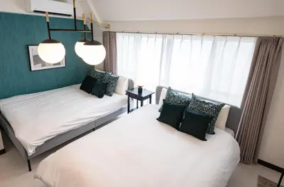 a bedroom with two beds and a window at Princet Shinjuku Building - Vacation STAY 15549 in Tokyo