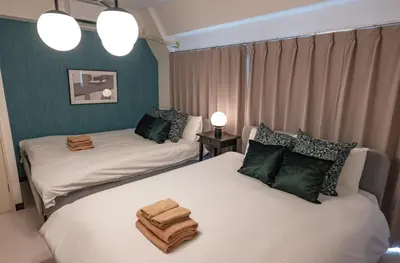 a bedroom with two beds with towels on them at Princet Shinjuku Building - Vacation STAY 15549 in Tokyo