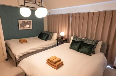 a room with two beds with towels on them at Princet Shinjuku Building - Vacation STAY 15549 in Tokyo