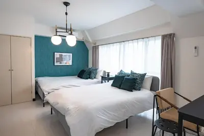 a hotel room with three beds and a table at Princet Shinjuku Building - Vacation STAY 15549 in Tokyo