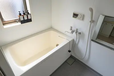 a white bath tub in a bathroom with a window at Princet Shinjuku Building - Vacation STAY 15549 in Tokyo