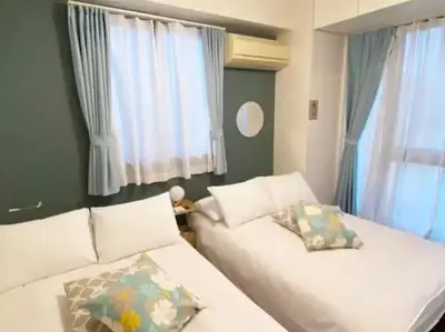 a bedroom with two white beds and windows at Regalia Hills Shibuya Dogenzaka - Vacation STAY 15550 in Tokyo