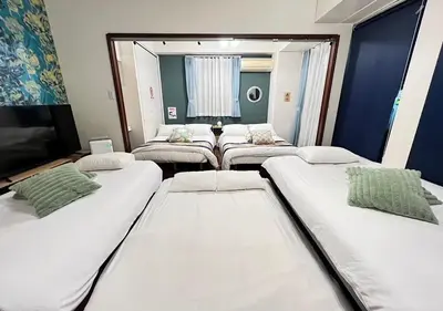 a room with four beds and a mirror at Regalia Hills Shibuya Dogenzaka - Vacation STAY 15550 in Tokyo