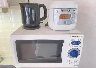 a microwave with a coffee maker on top of it at Regalia Hills Shibuya Dogenzaka - Vacation STAY 15550 in Tokyo
