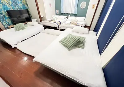 a hospital room with three beds and a tv at Regalia Hills Shibuya Dogenzaka - Vacation STAY 15550 in Tokyo