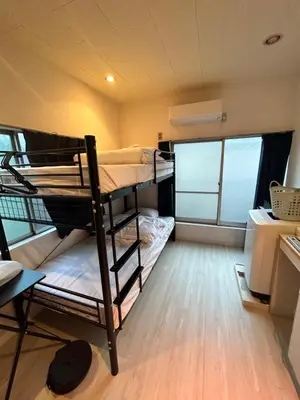 a small room with two bunk beds in it at Meguro Apartment in Tokyo