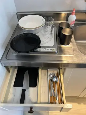 a stove top with a plate on it in a kitchen at Meguro Apartment in Tokyo