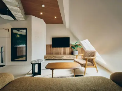a living room with a couch and a table and a tv at illi Com Shimokitazawa in Tokyo