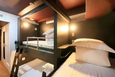 a couple of bunk beds in a room at Centurion Hotel Ikebukuro Station in Tokyo