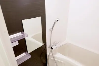 a bathroom with a bath tub with a shower head at \u5922\u306e\u820e Asakusa Horizon Bleu in Tokyo
