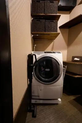 a washing machine is sitting in a room at HOTEL Lee in Tokyo