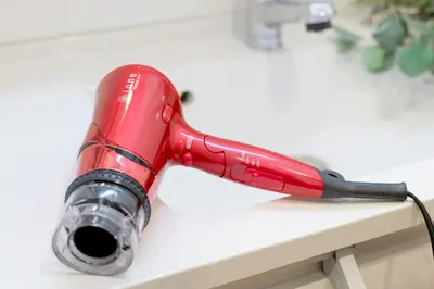 a red vacuum sitting on top of a table at Shinjuku City House \u65b0\u5bbf\u30b7\u30c6\u30a3\u30cf\u30a6\u30b9 in Tokyo
