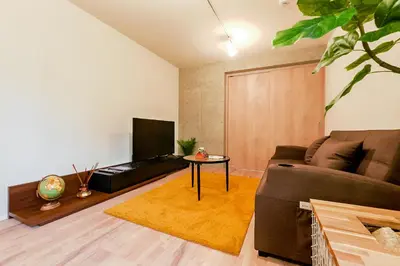 a living room with a couch and a tv at ACOE ASAKUSA - 3 minutes from station in Tokyo