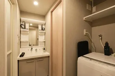 a small bathroom with a sink and a washing machine at ACOE ASAKUSA - 3 minutes from station in Tokyo