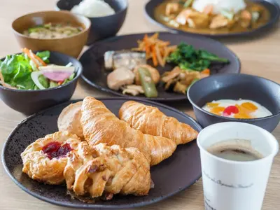 a table with plates of food and a cup of coffee at Super Hotel Shinagawa Aomono-Yokocho in Tokyo