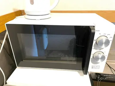 a microwave oven sitting on top of a counter at Tokyo Stay Kitashinjyuku in Tokyo