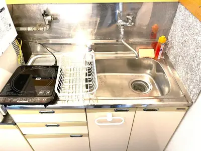 a kitchen counter with a sink and a microwave at Tokyo Stay Kitashinjyuku in Tokyo