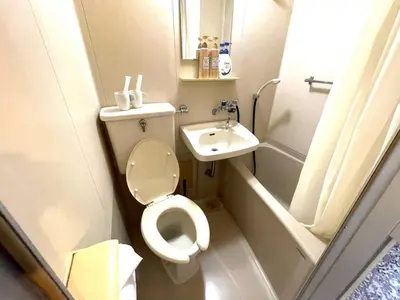 a small bathroom with a toilet and a sink at Tokyo Stay Kitashinjyuku in Tokyo